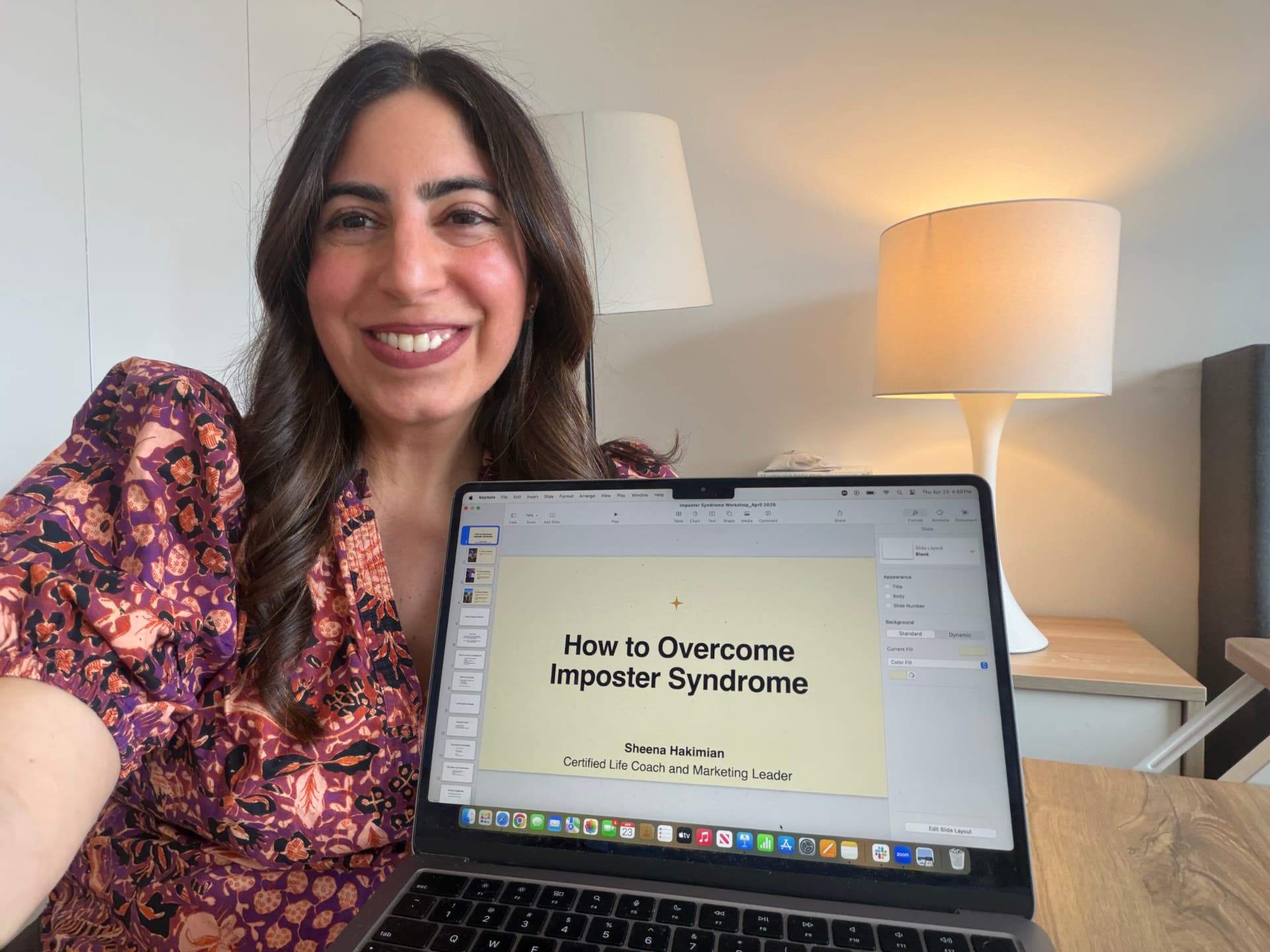 Sheena with her laptop showing her ‘How to Overcome Imposter Syndrome’ workshop slides